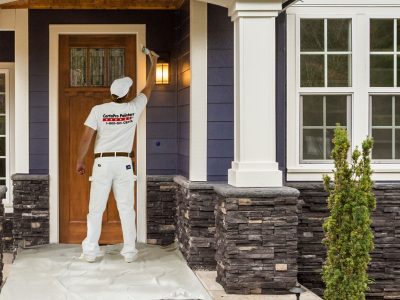 painter working on trim around front door