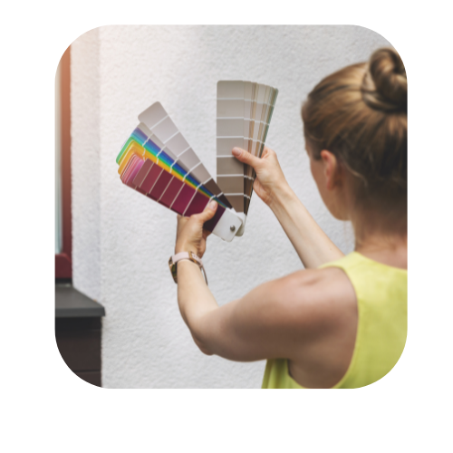 Woman choosing paint colors with a color fan deck
