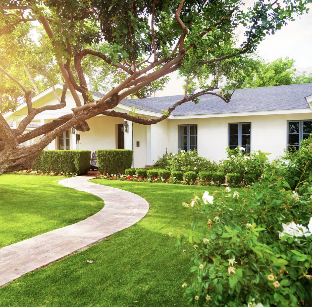White ranch home with pale blue window grids.
