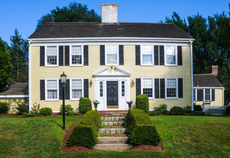 Yellow colonial with black shutters
