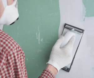 Guy doing DIY drywall repair
