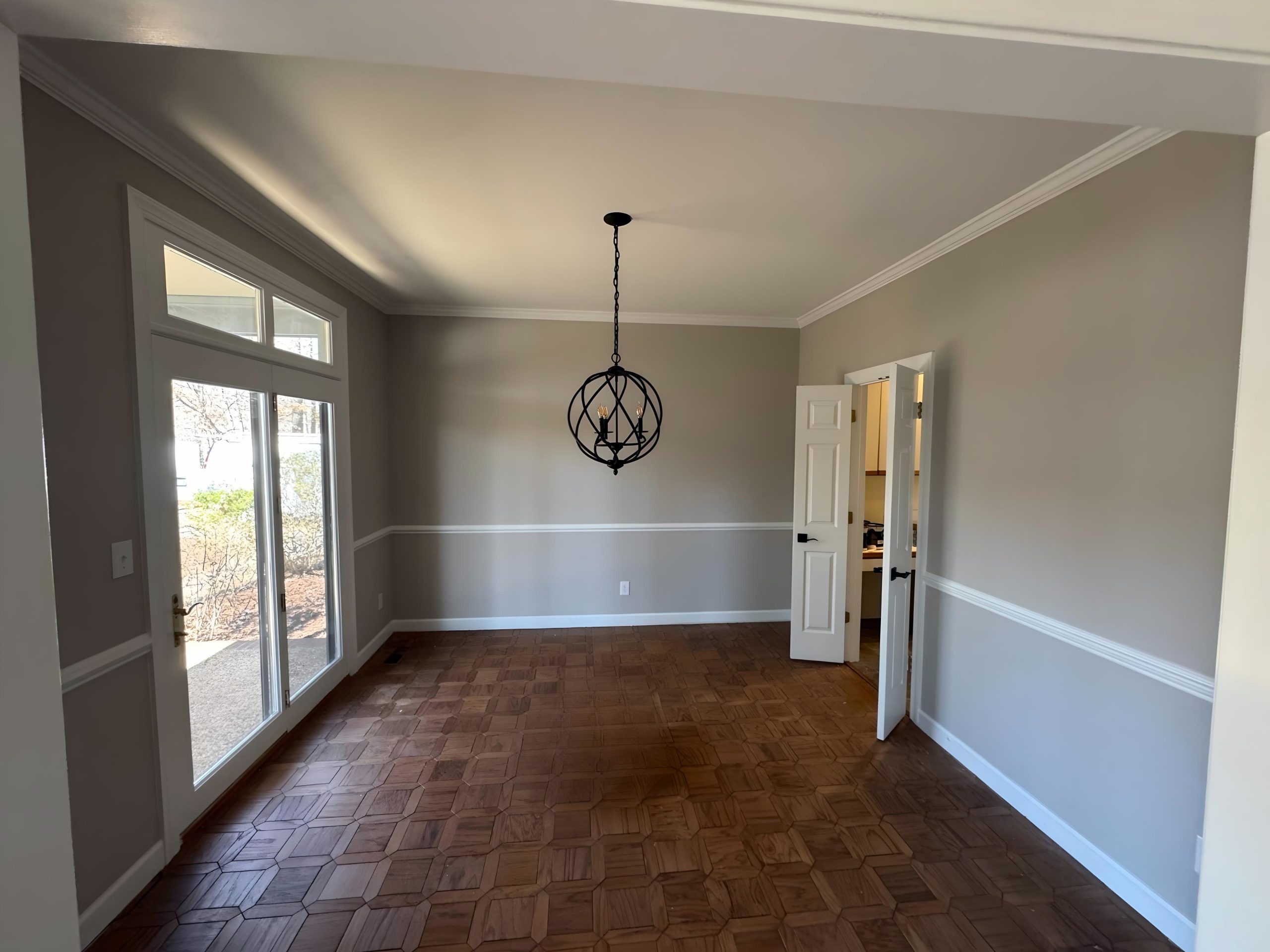 room with painted walls and chair rail