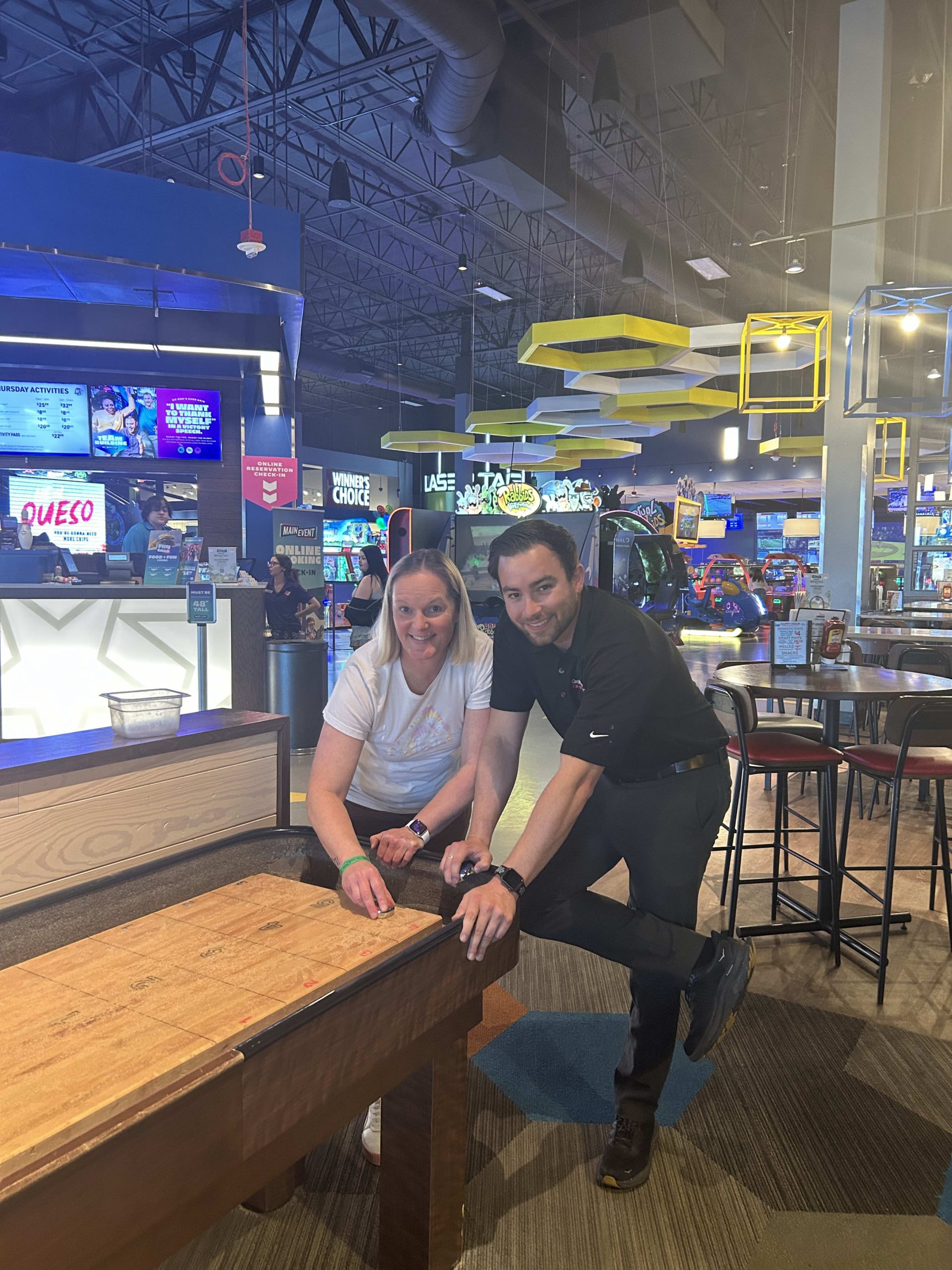 man and woman playing shuffleboard