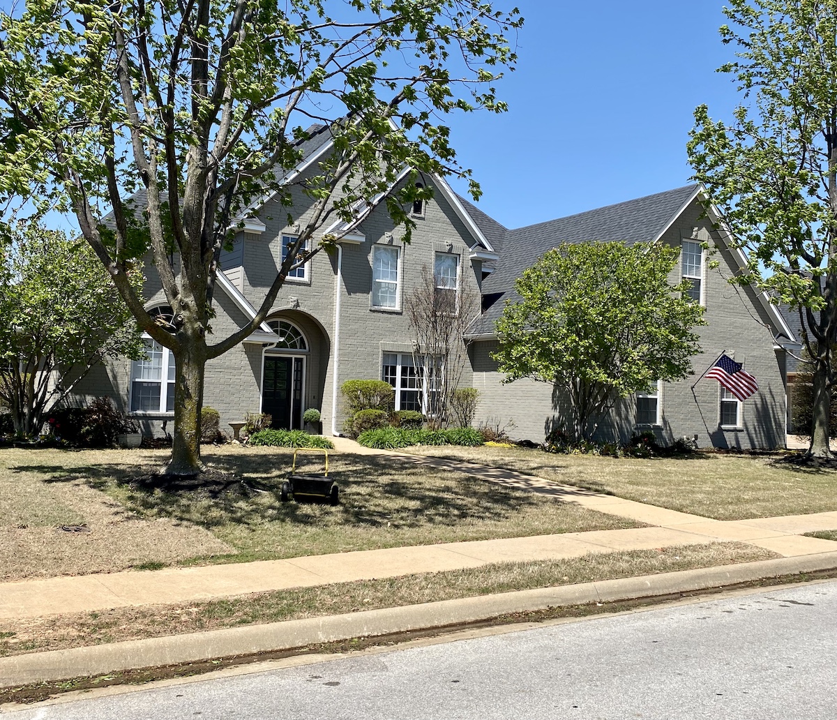 Brick house after exterior repainting in Rogers, Arkansas.