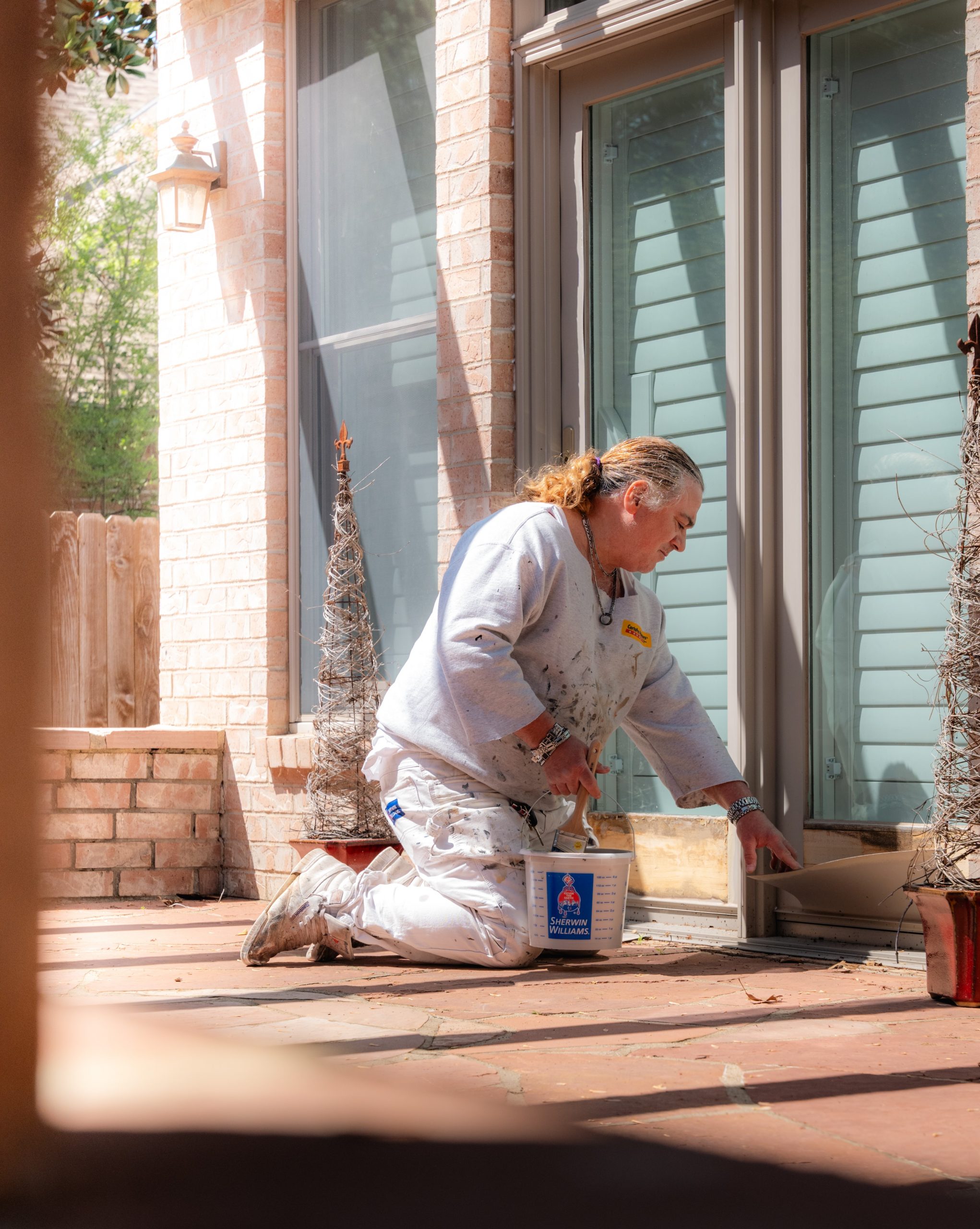 painter working outside house