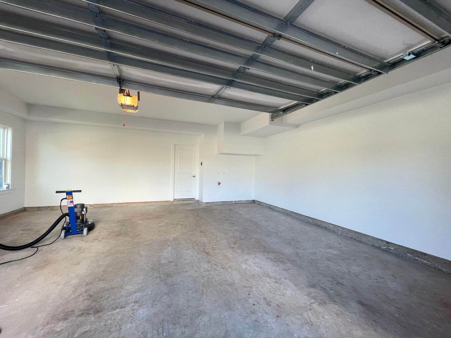 Wall Repair and Concrete Garage Flooring Before Photo