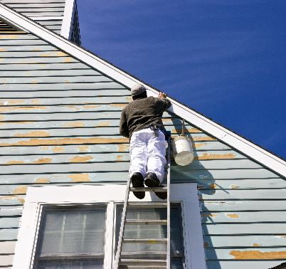 man painting house