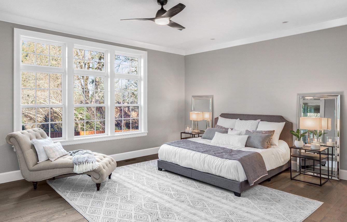 master bedroom with gray walls and white trim