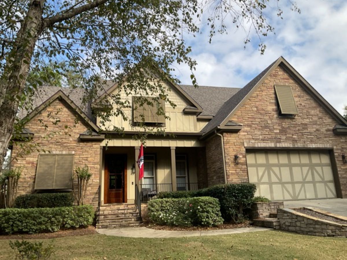brick house with off white siding