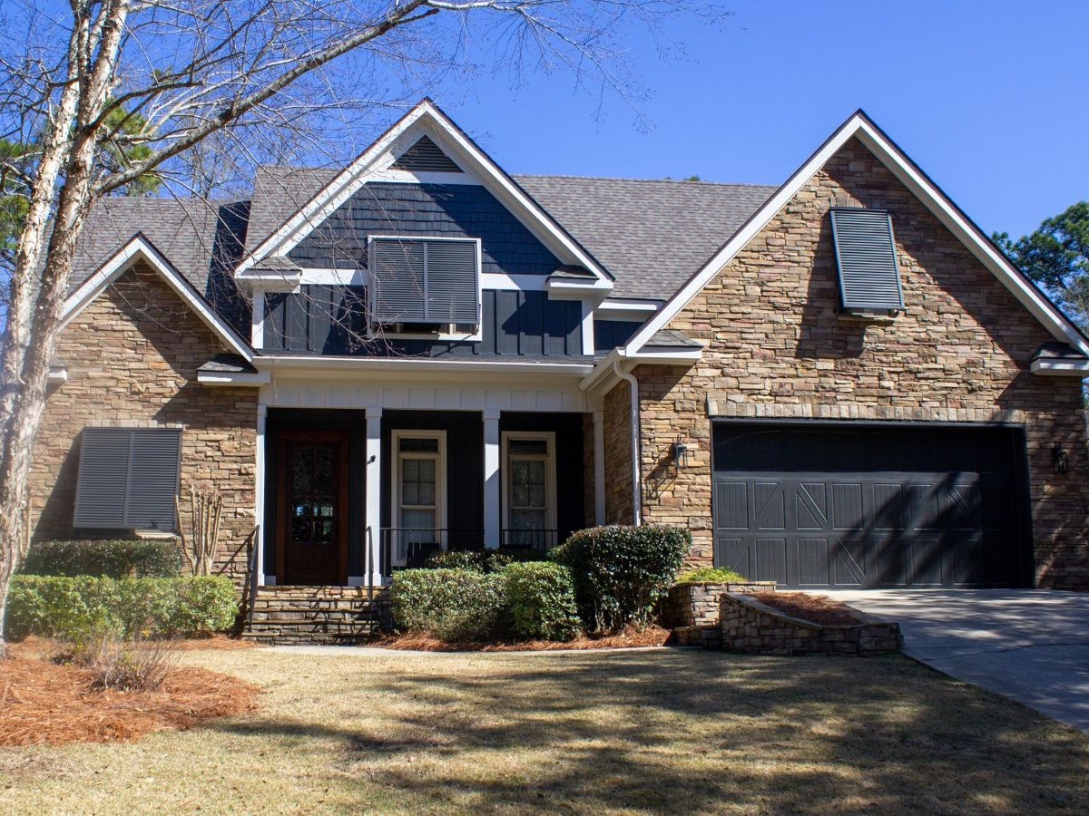 house with stone and blue painted siding and accents