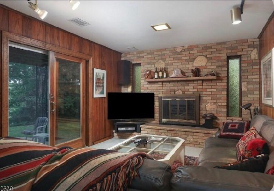 Panelled den and mixed brick before repainting.