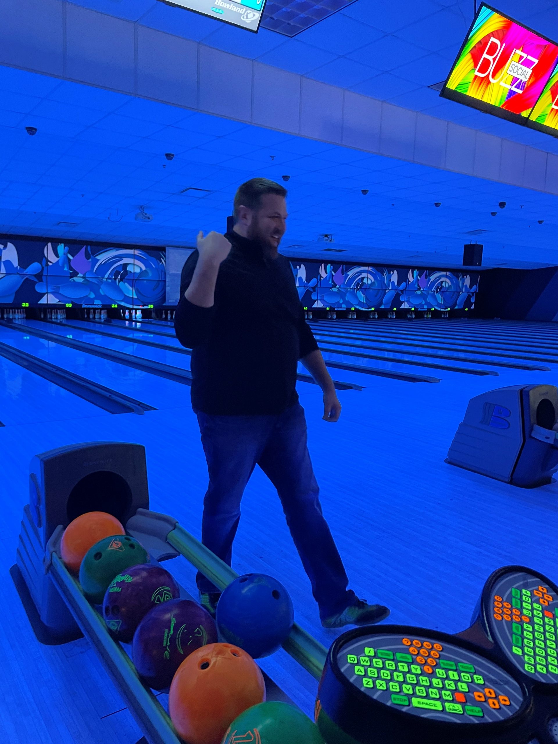 certapro employee celebrating strike at bowling alley