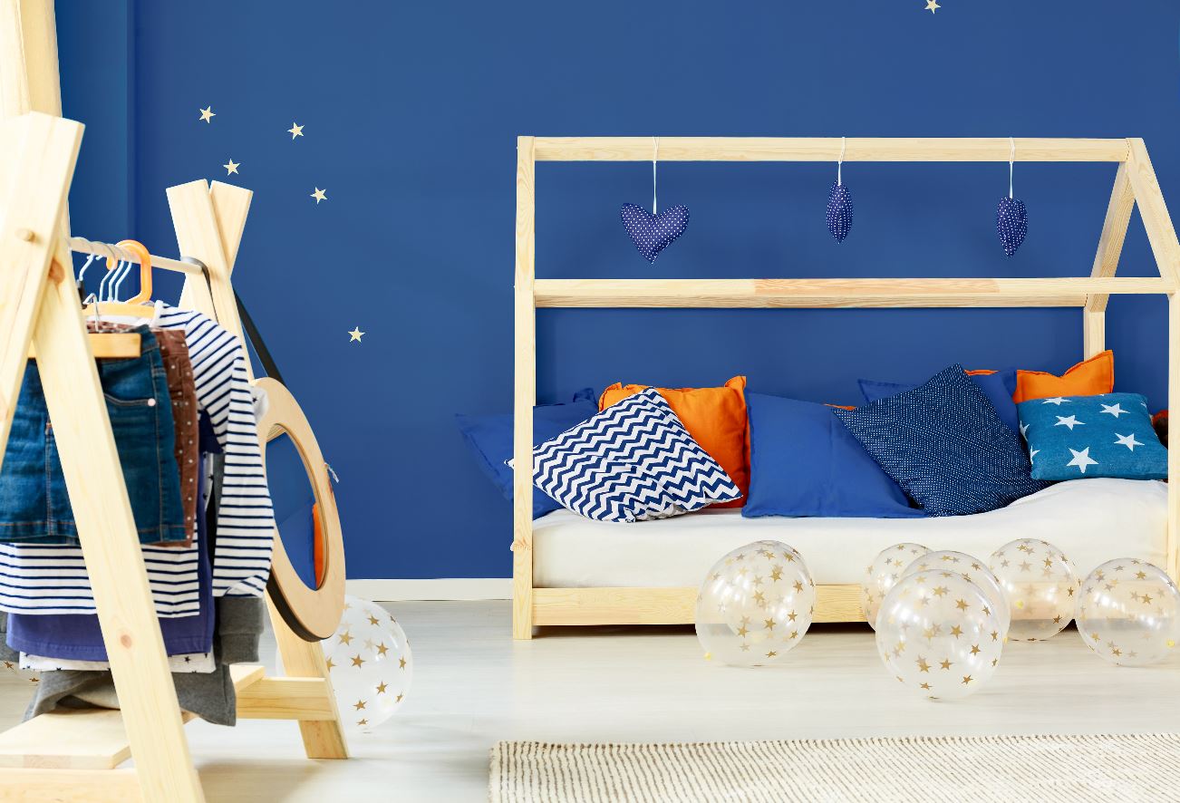 A bedroom painted in a bold shade of navy blue.