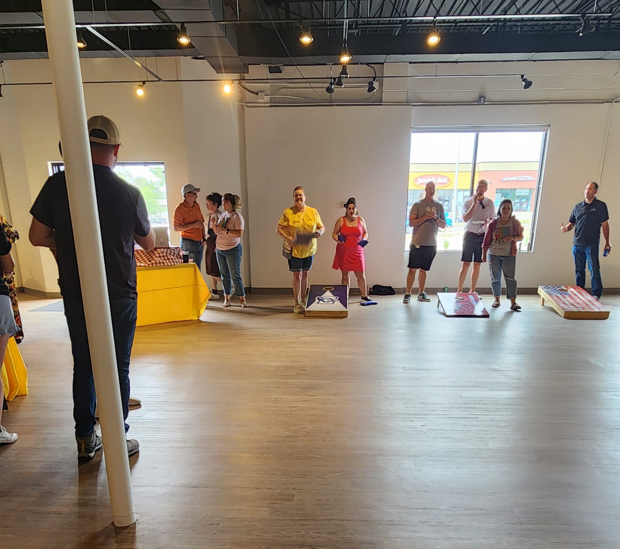 Team members playing cornhole at the PJ Morgan Real Estate BBQ Bags Tournament.