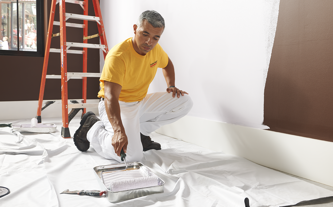 interior house painters with a roller and paint tray.
