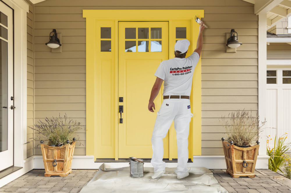 Crew Member Painting a Door