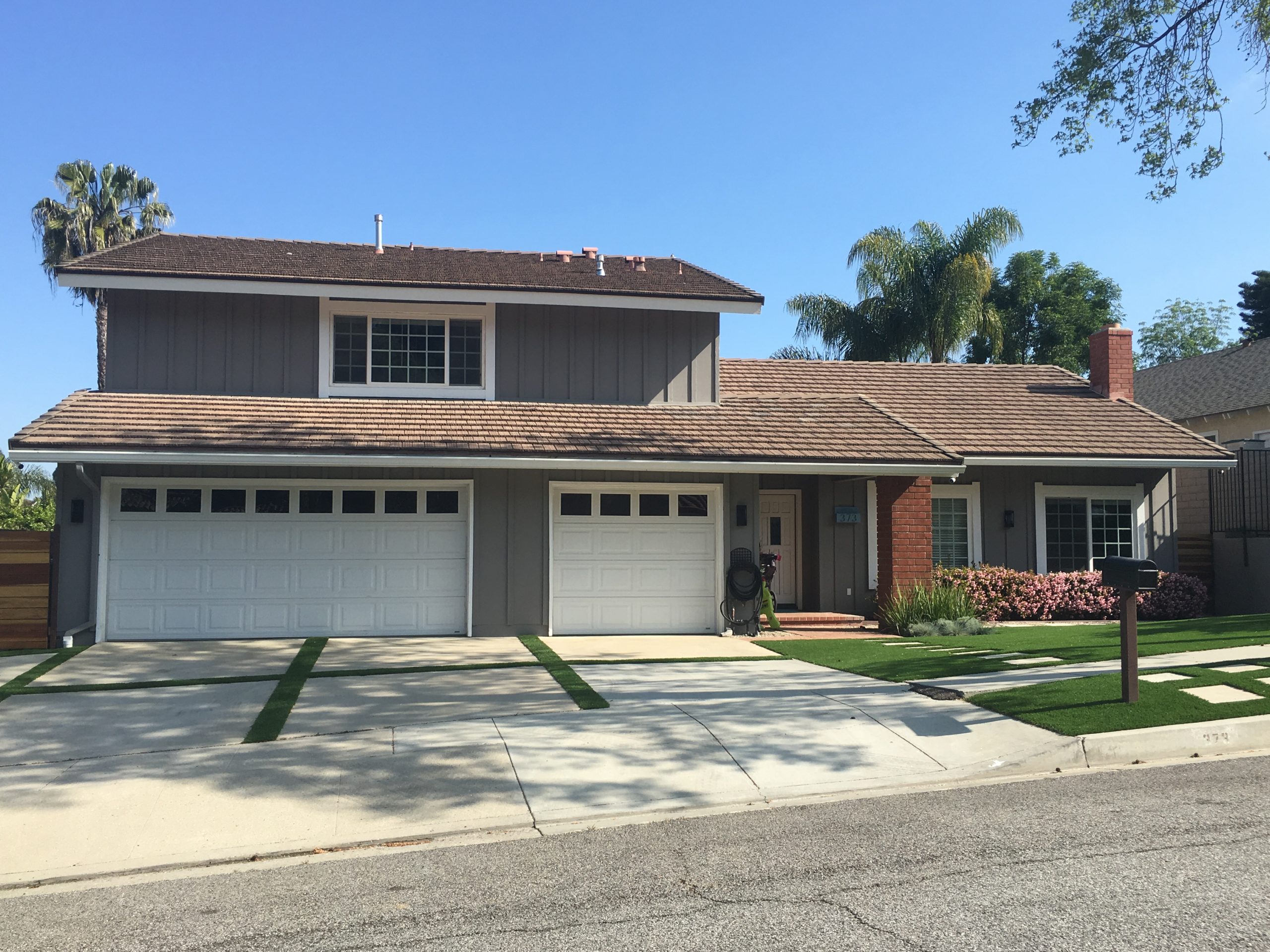 wood panel home painted brown with white doors and trim