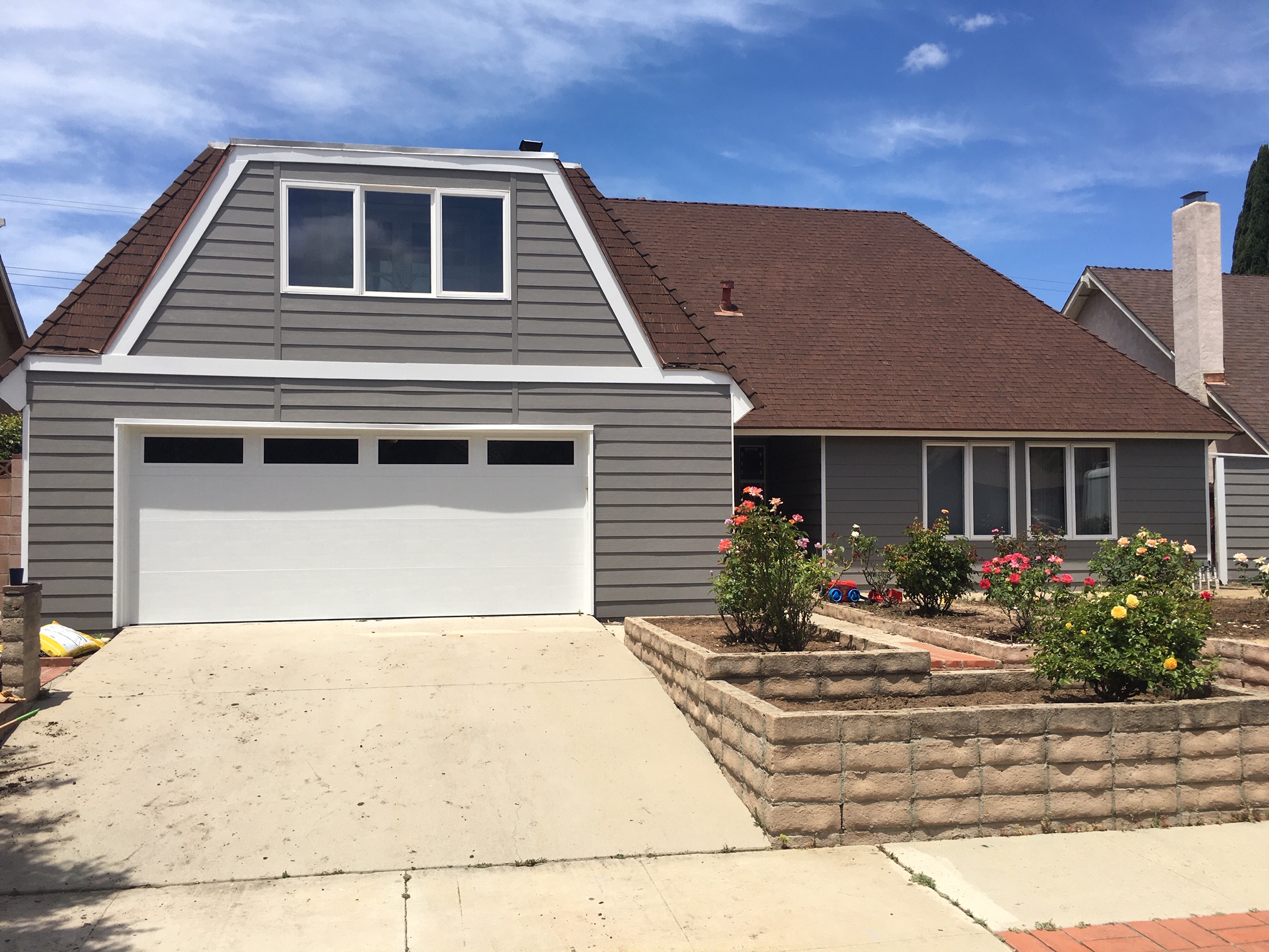 wood siding house with tan painted exterior and white trim