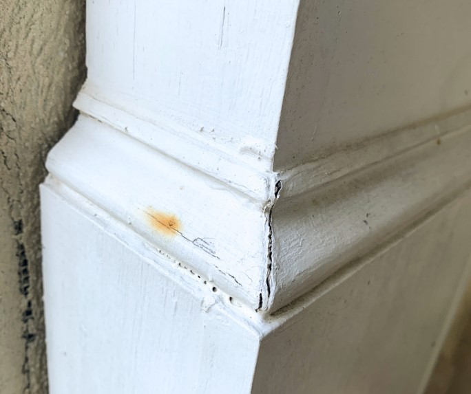 wooden column with nail rust and wood shrinkage