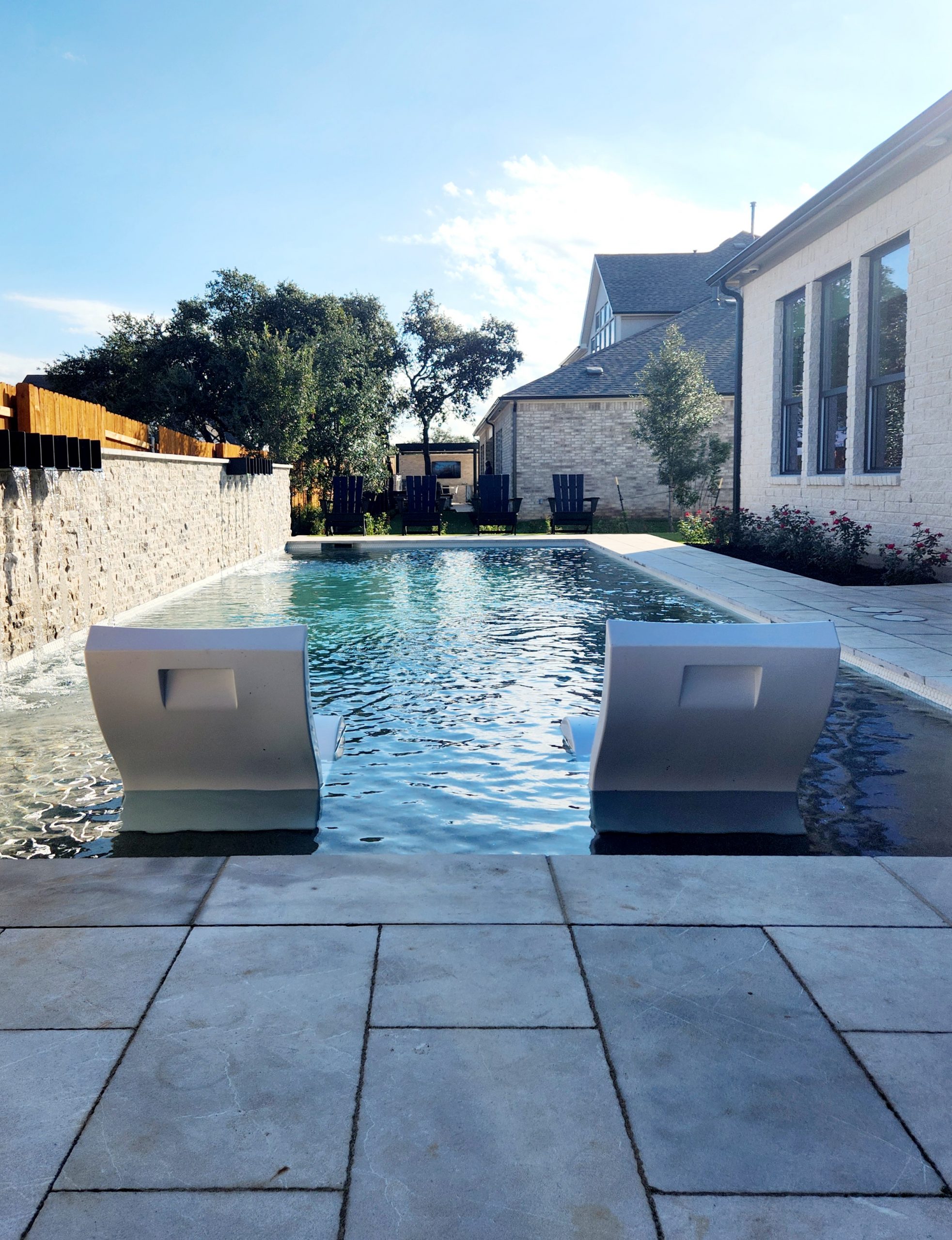 seats at the edge of a pool