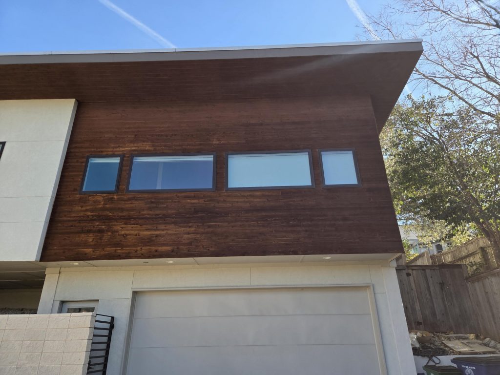 house exterior with restained wood siding
