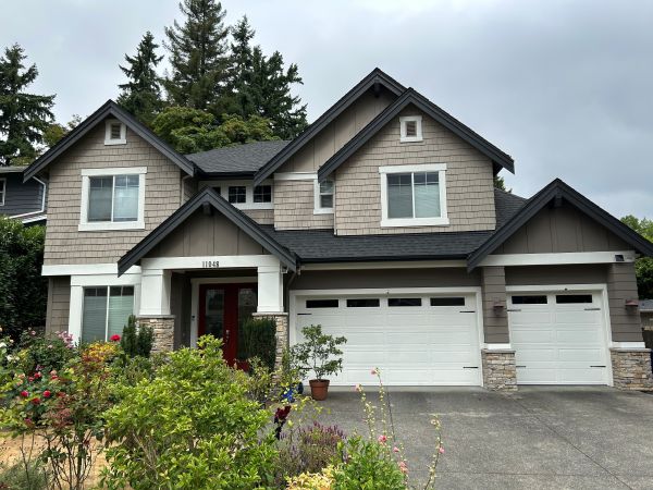 driveway view of house and garage after paint refresh