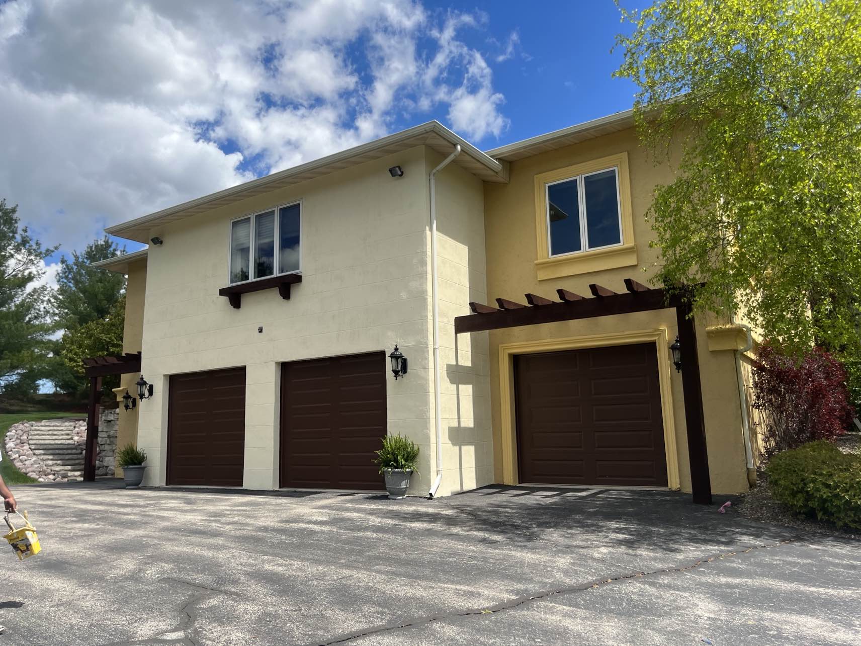 Stucco home exterior and pergola painting in Fond du Lac, WI