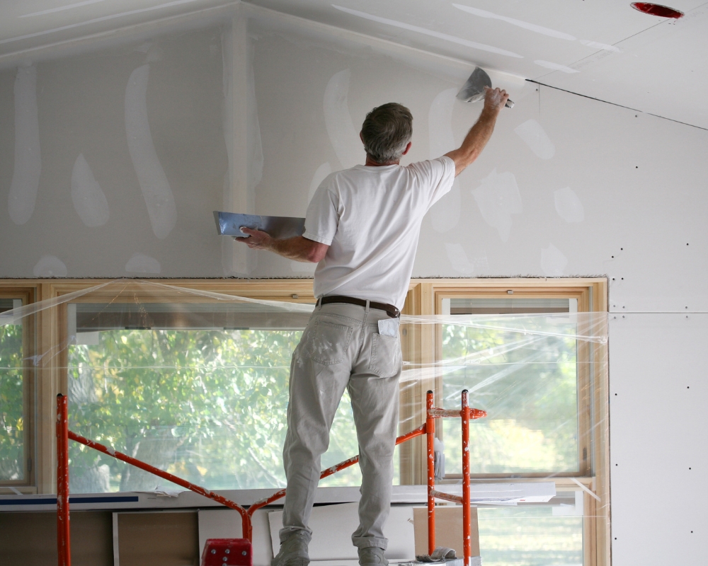 Man painting drywall