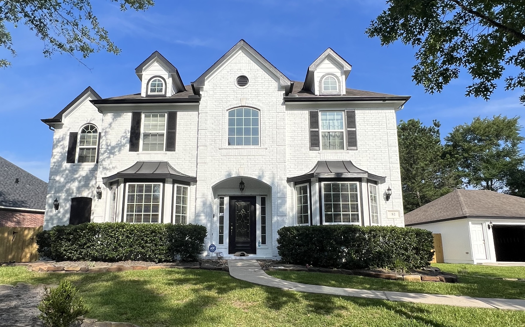 Painting Red Brick and Siding in Pure White After