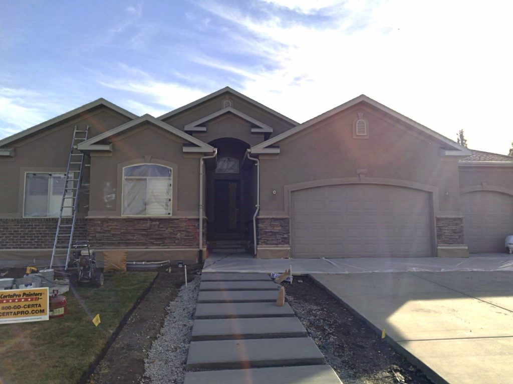 Before stucco repainting in West Jordan, Utah.