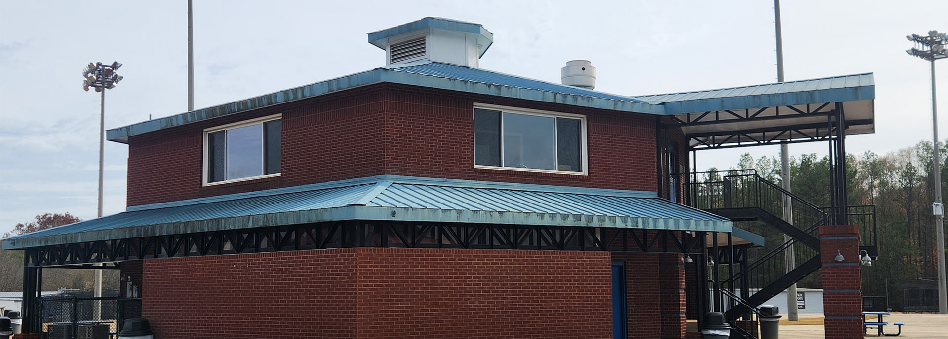 Before basball park metal roof paitning Hoover, AL