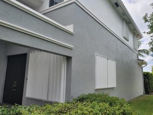 newly painted accordion shutters on exterior of house
