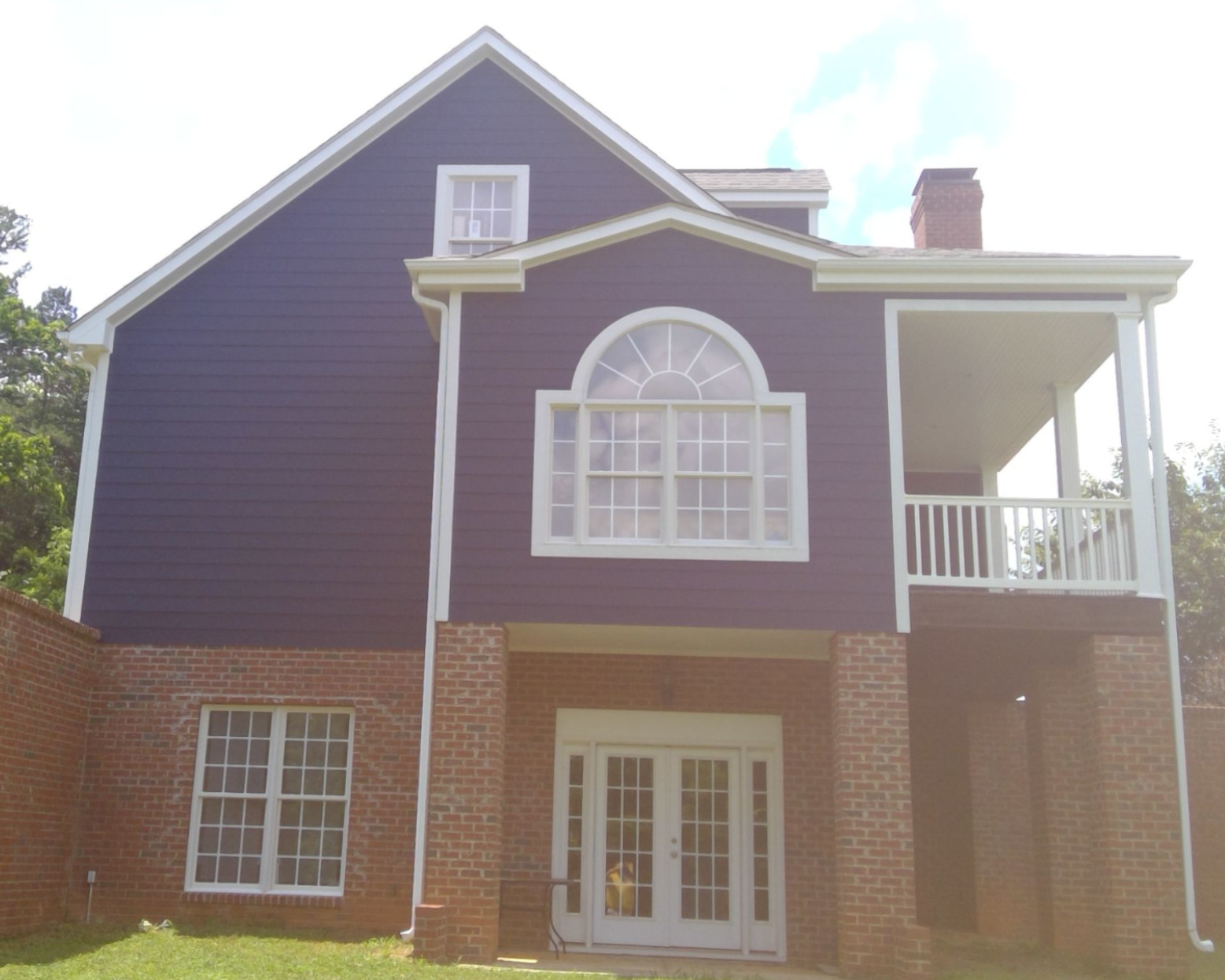 house side view after painting blue by certapro