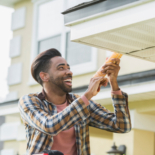 man making repairs to residential exterior