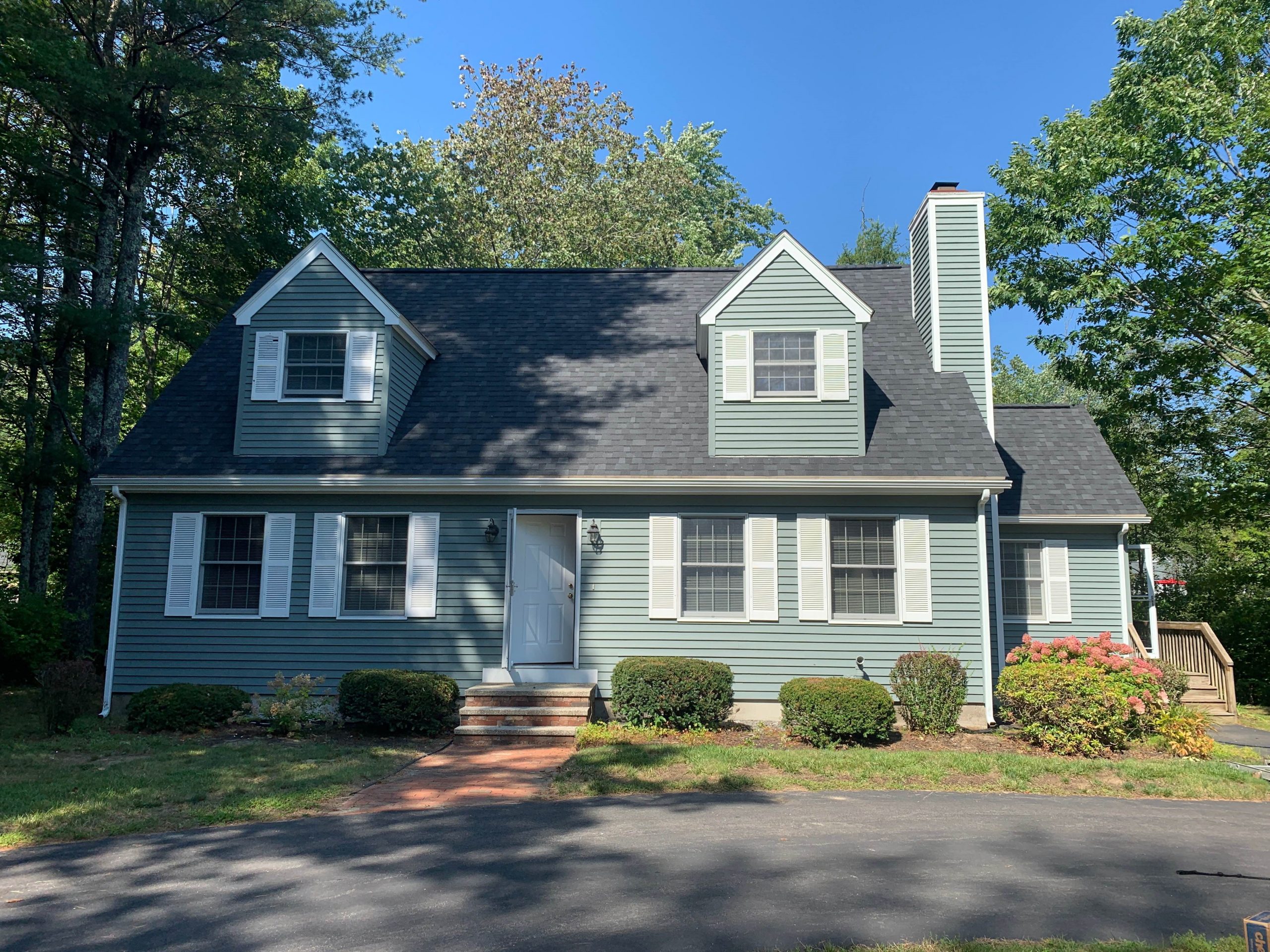 Green and white home after painting