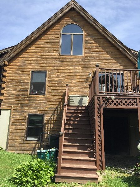 Log Home in Freeport, ME, before log home staining by CertaPro Painters of Maine