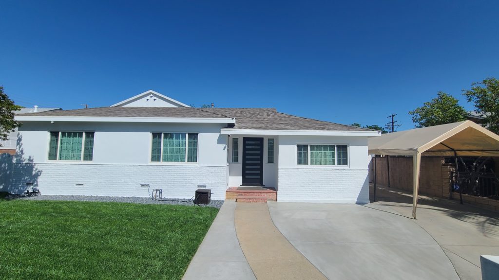 The house in Encino after the wood trim, stucco, and brick were repainted.