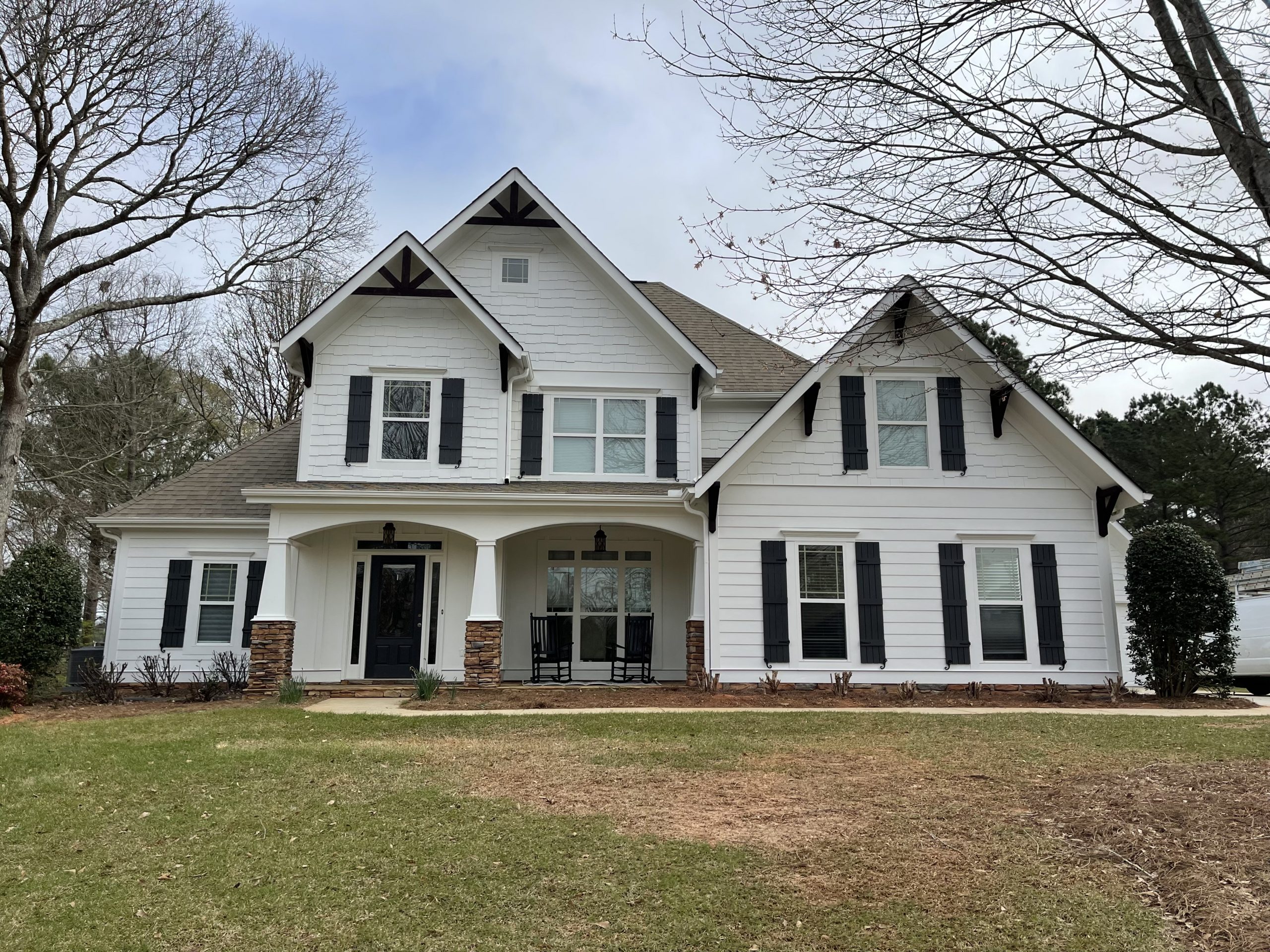 House with alabaster siding and iron ore shutters