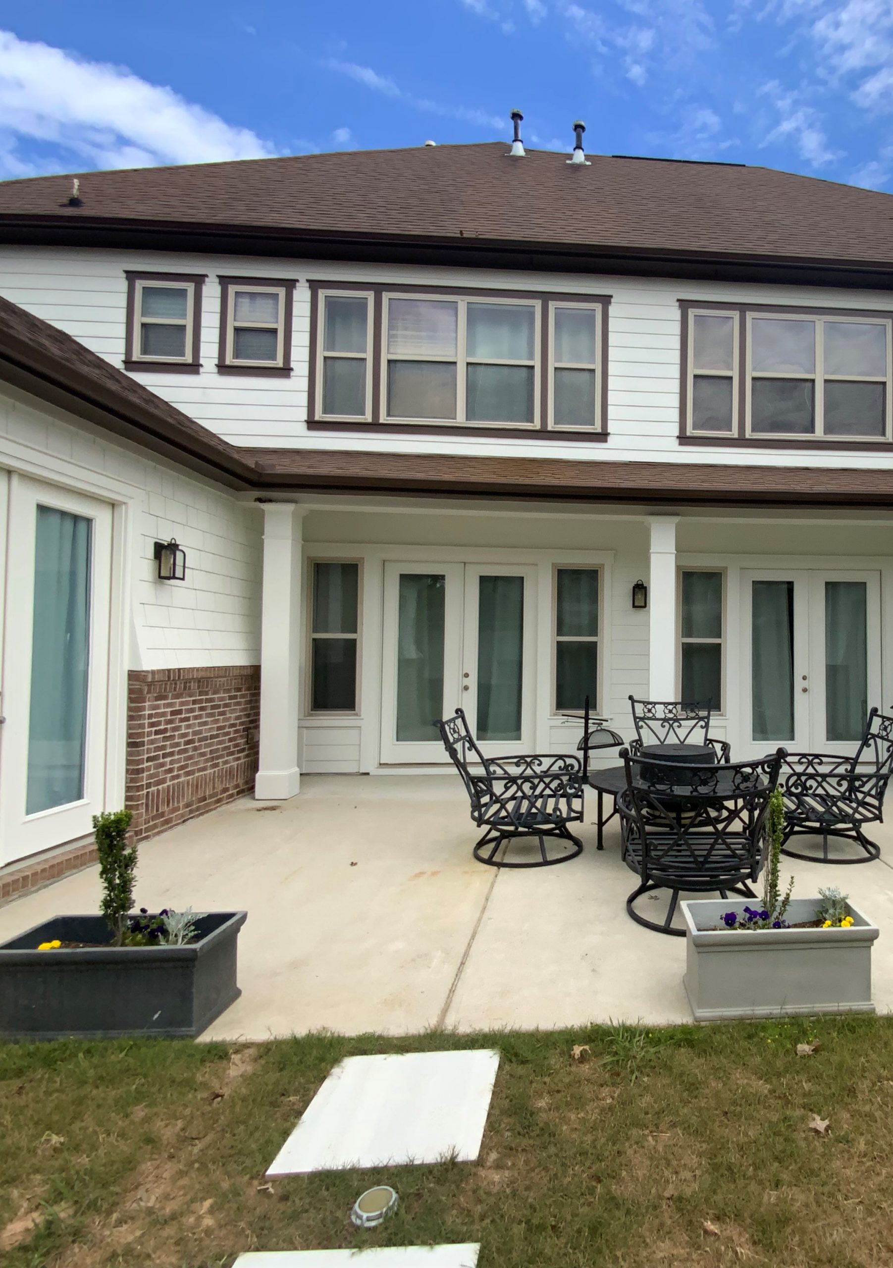 Back of white house in Fairburn, GA after completed residential exterior painting project by CertaPro Painters of Peachtree City/Coweta County, GA