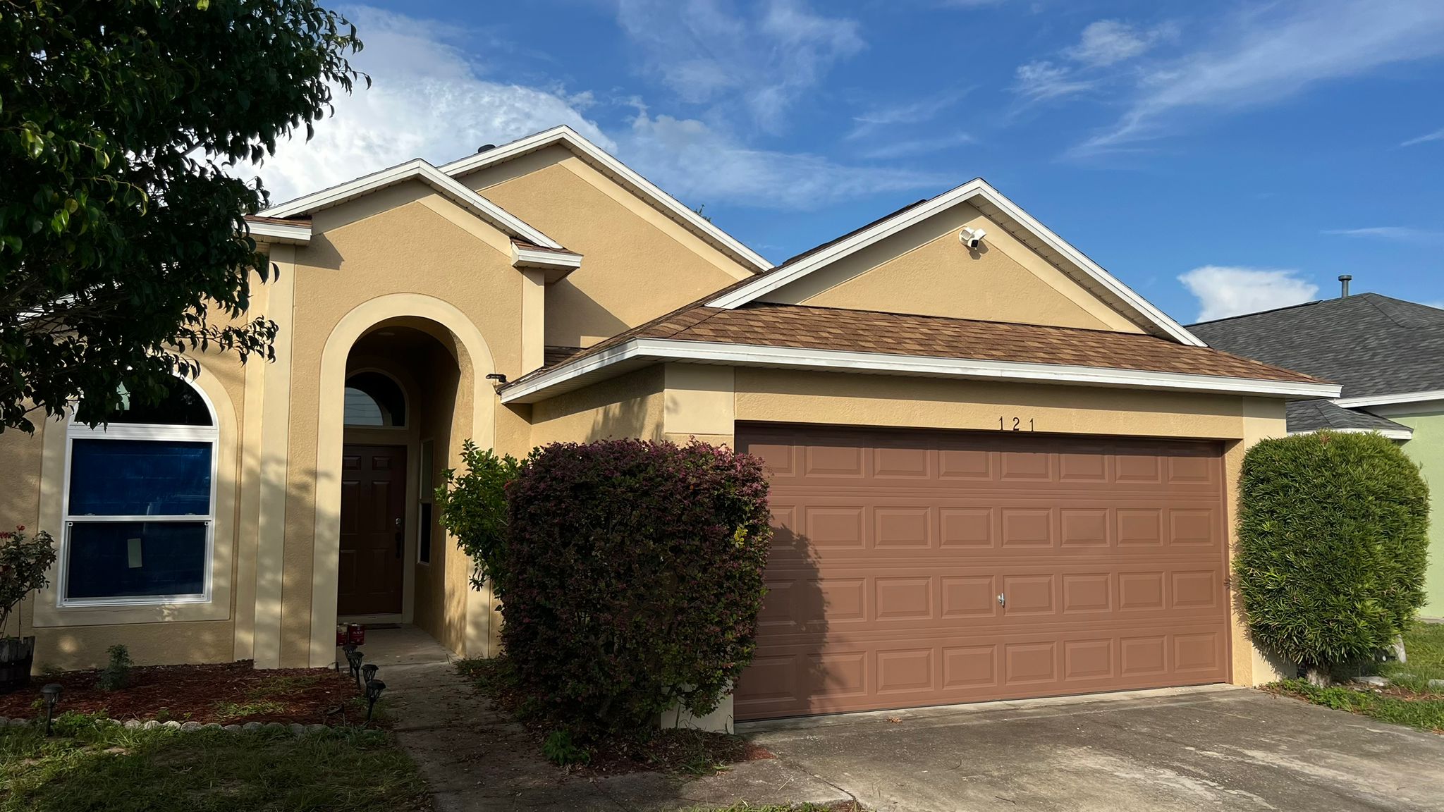 Tan exterior painting project in residential home in Haines City, FL.