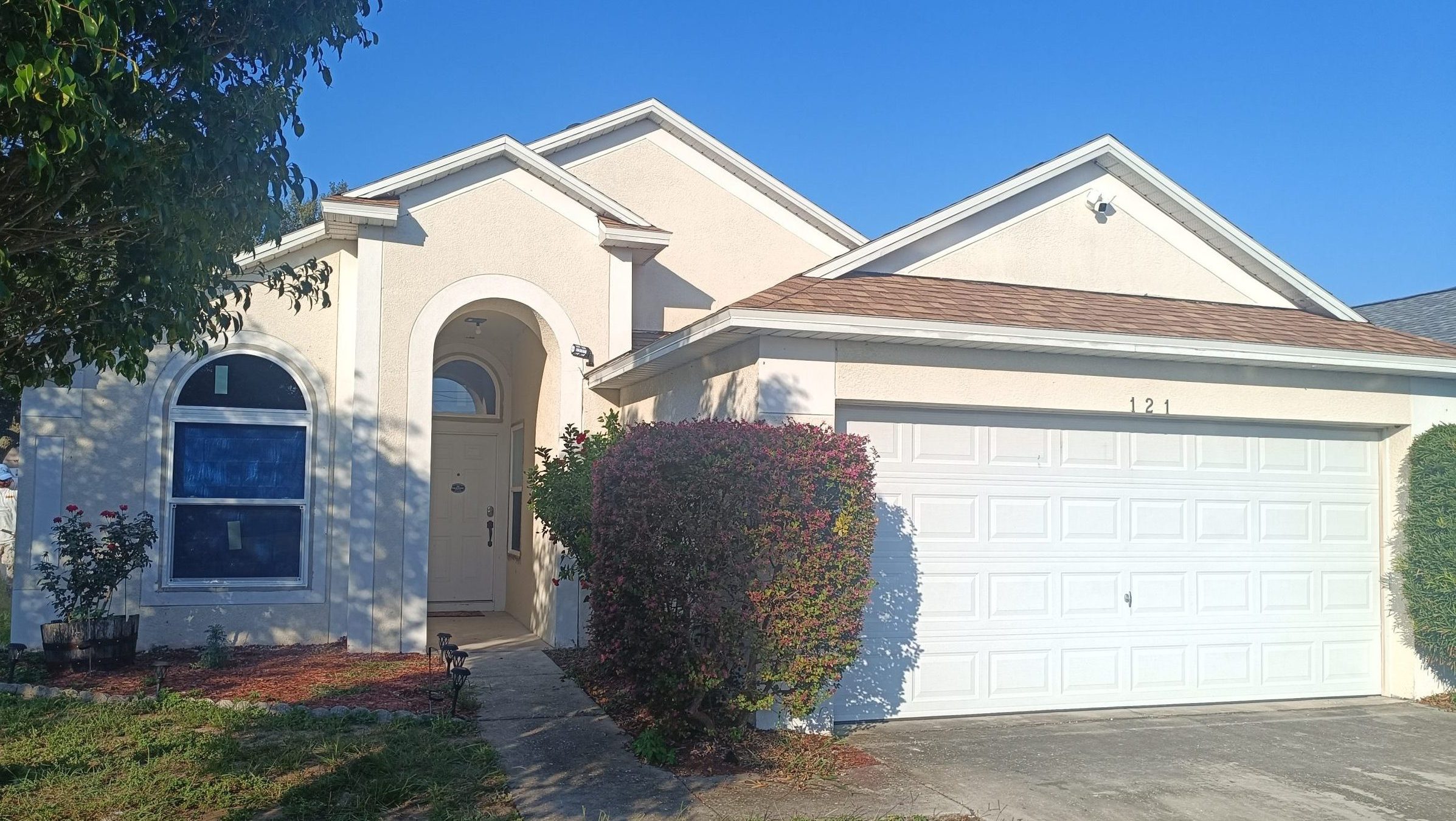 Before painting project with outdated white exterior in Haines City, FL.