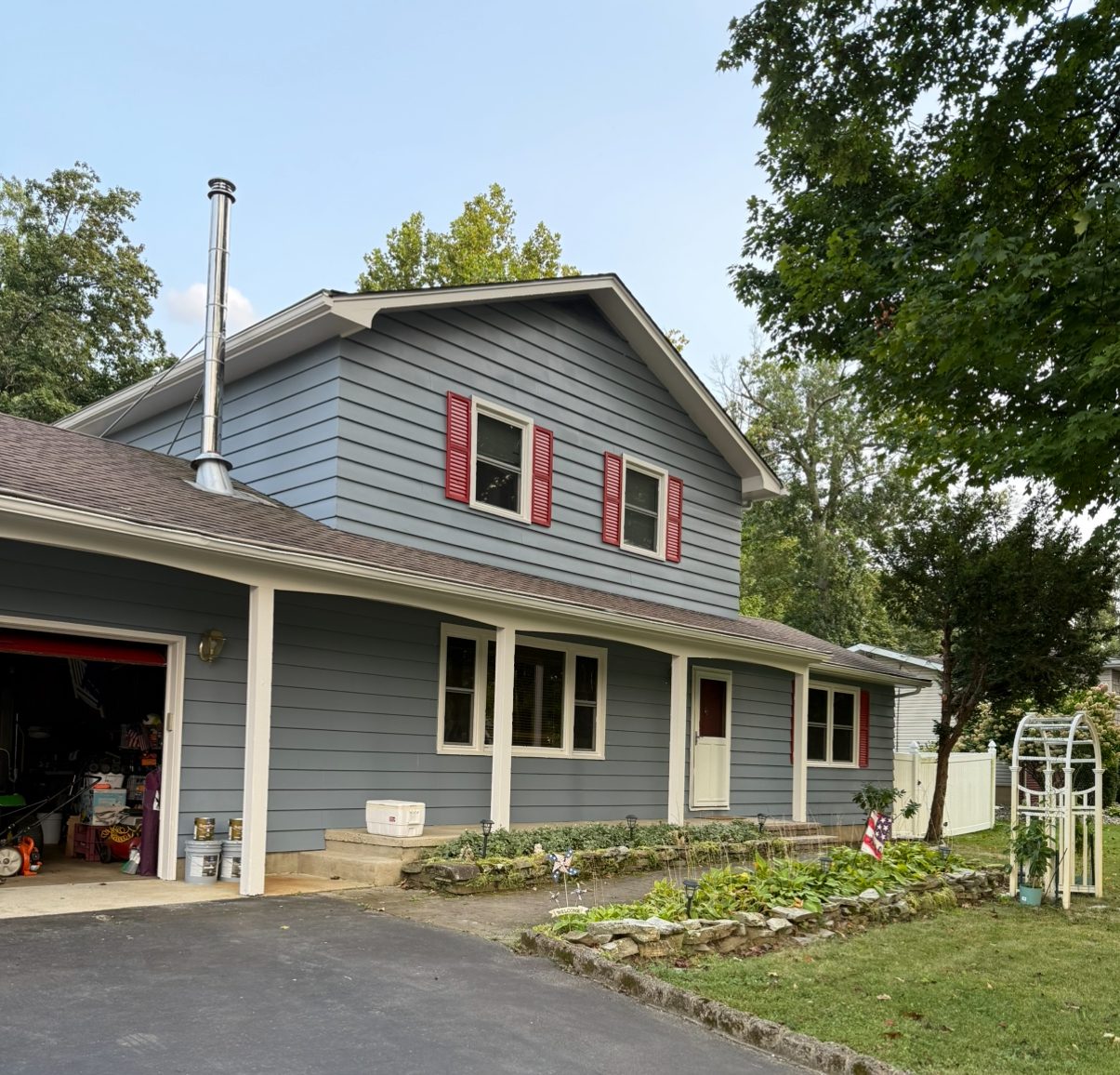 blue gray siding on home with red shutters