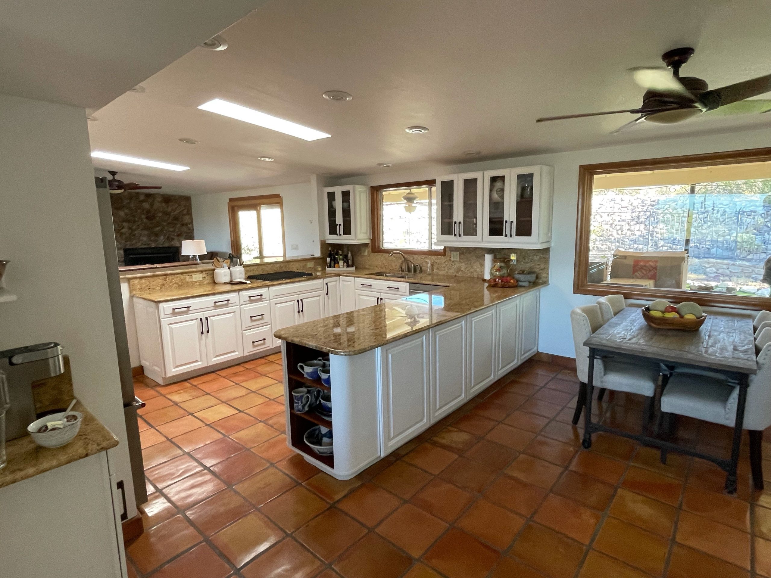 kitchen with white cabinets and dining room