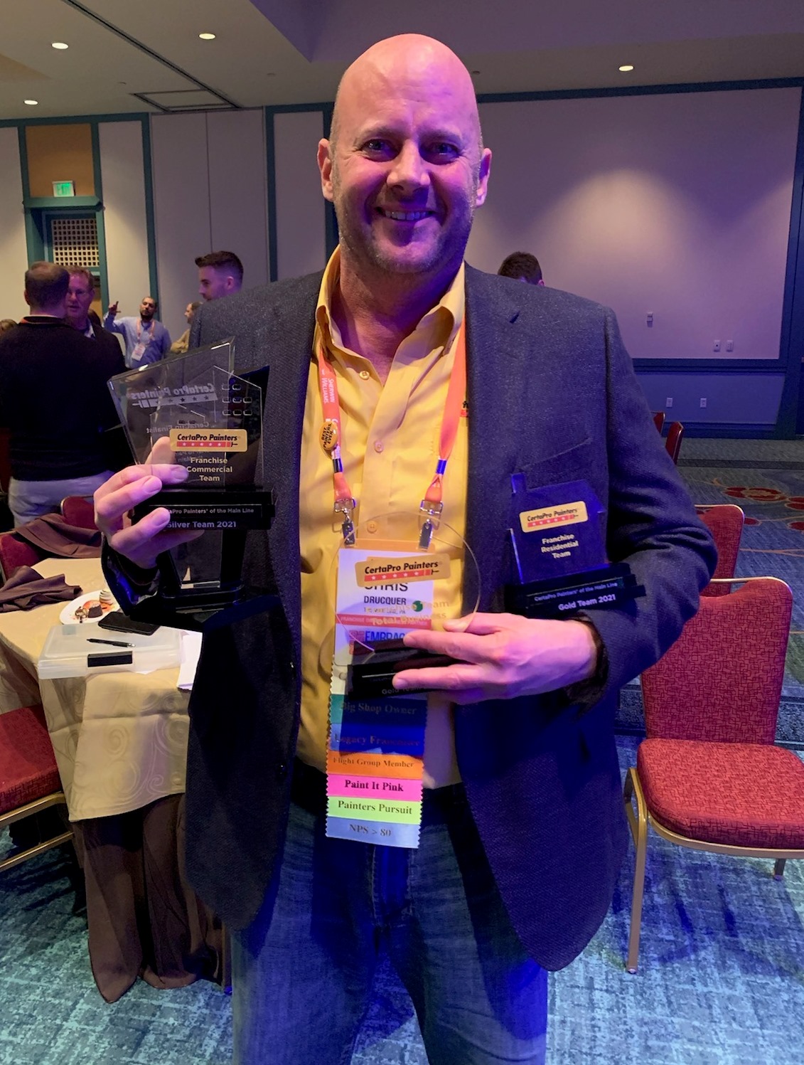 Chris Drucquer posing with awards