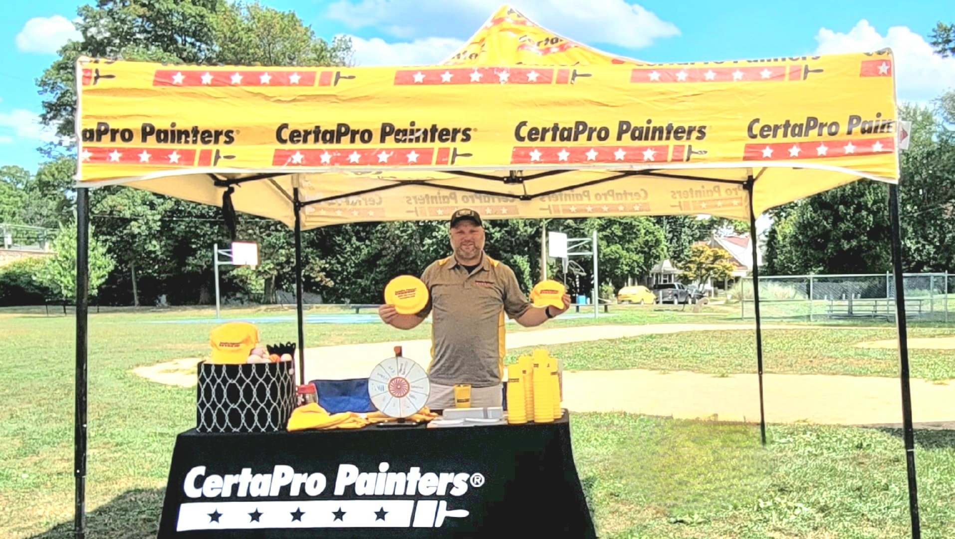 Man at CertaPro Painters table outside
