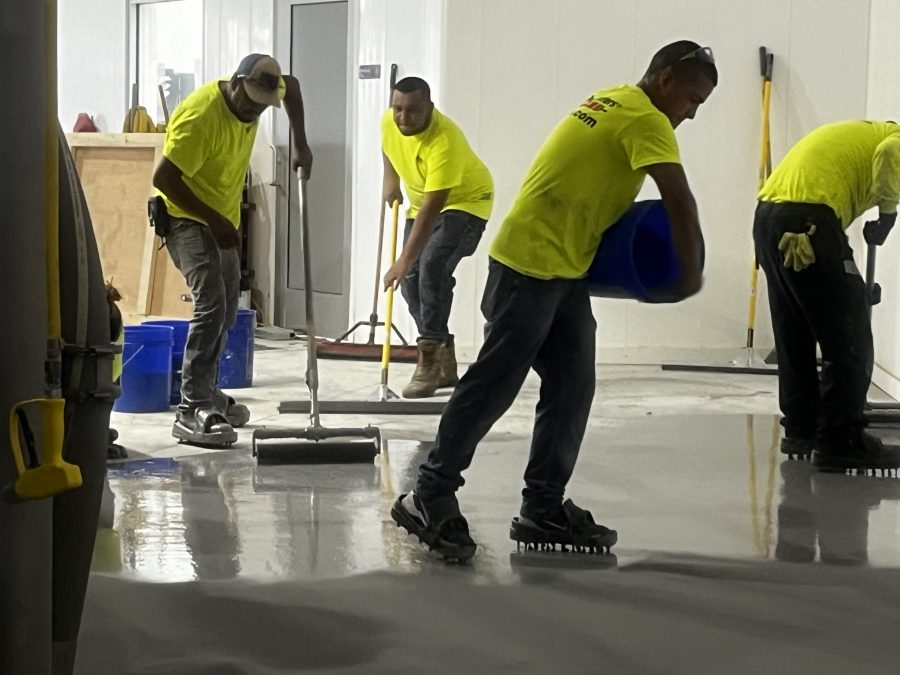 McCarty Farms Commercial Flooring Project spreading product onto the floor Preview Image 10