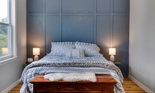Bedroom With Blue Accent Wall And Carpentry