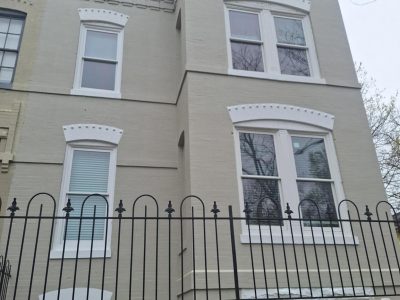 home exterior with painted brick and frence