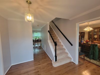 home staircase with painted railing and walls
