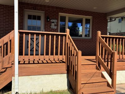 Stained wooden deck attached to home